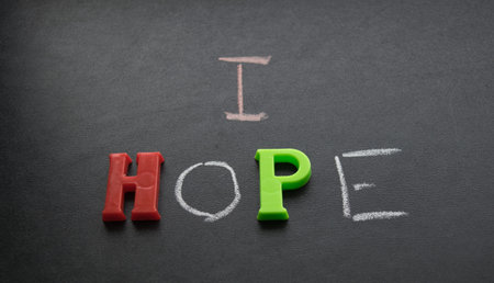 Inscription I hope with chalk and plastic letters on a dark backgroundの写真素材