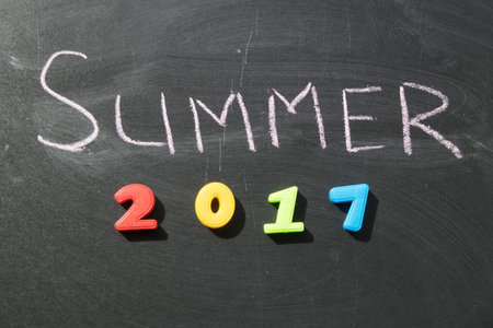 Summer chalk and multi-colored figures 2017 on a dark slate background