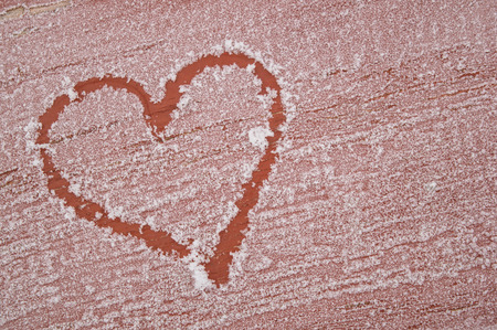 background frosted brown board with the drawn heart on the leftの写真素材