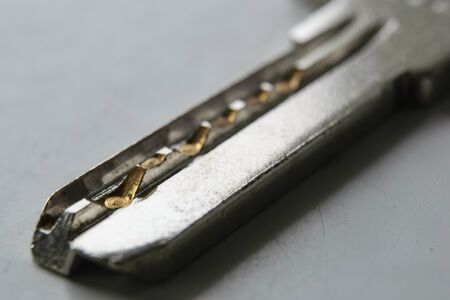 Flat metal key shot very close-upの写真素材