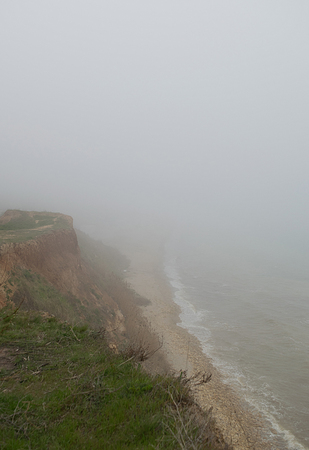 Steep seaside of the Black Sea in dense fogの写真素材