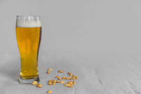 Beer with peanuts on a gray tableの写真素材
