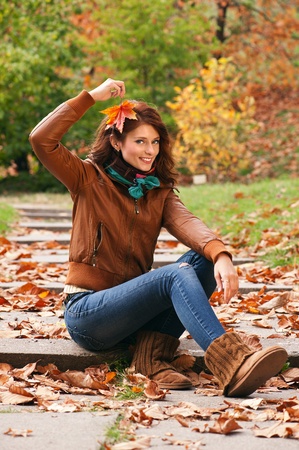 Young pretty woman at the autumn parkの写真素材