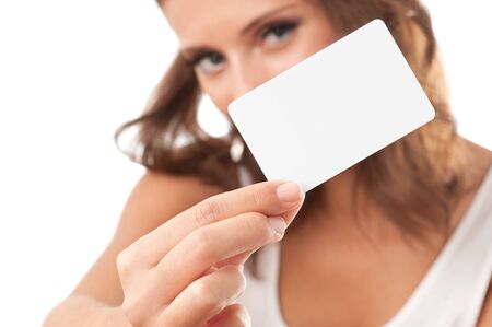 Woman hand holding white empty blank business card, shallow DOF, face in blurの写真素材