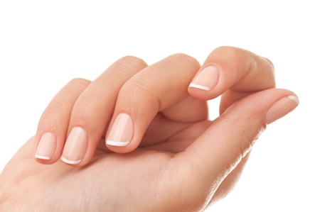 Close-up of womans hand with French manicure isolated on white.の写真素材
