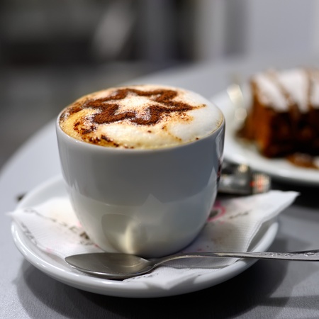 Cup of coffee and cake in cafe, shallow DOFの写真素材