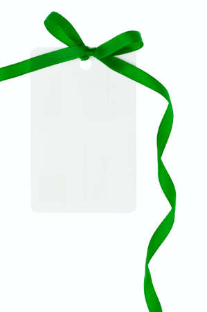 A blank gift or price tag tied with green ribbon isolated on a white backgroundの写真素材