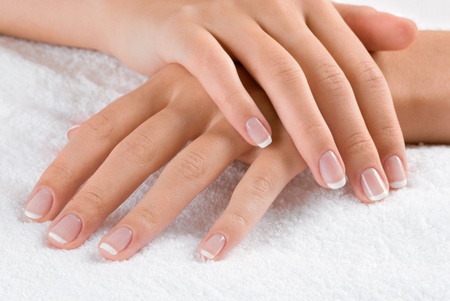 Nice hands on white towel. Soft manicure.の写真素材