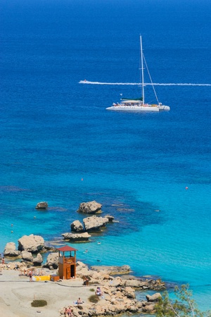 Catamaran anchoring at coastline の写真素材