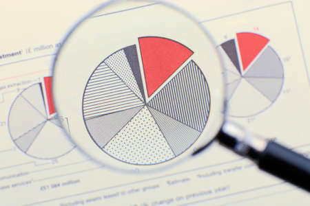 Magnifying glass focusing on a diagramの写真素材