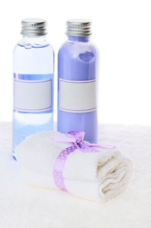 Relaxing beauty setting with luxurious towel, shower gel and bath foam isolated on white backgroundの写真素材