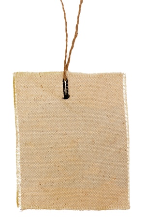 A blank rectangle cloth label with thread isolated on white backgroundの写真素材