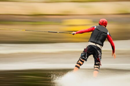 Wakeborder is riding. Motion blurred panning shot.の写真素材