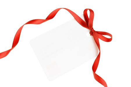 A blank gift or price tag tied with red ribbon isolated on a white background
の写真素材