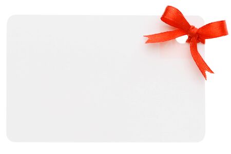 A blank gift or price tag tied with red ribbon isolated on a white backgroundの写真素材