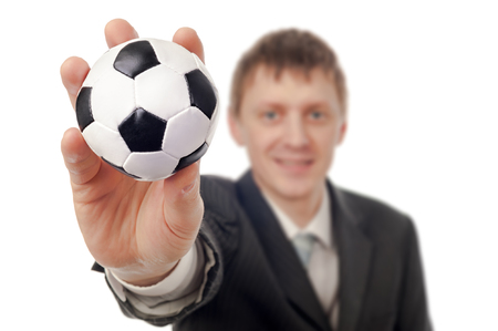 Businessman with football isolated on white.の写真素材