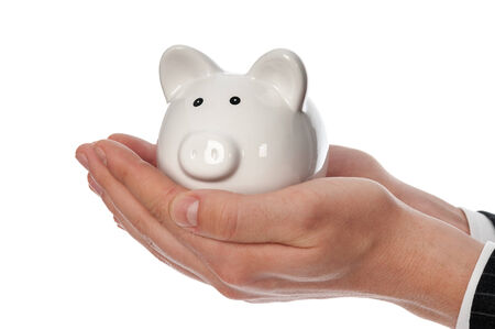 Man's hands holding white piggy bank isolated on white.の写真素材
