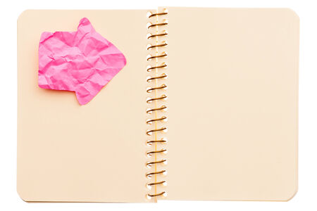 Yellow notebook with pink arrow label isolated on white background の写真素材