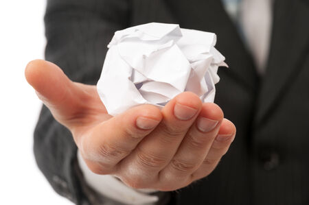 Man holding creased paper in his handの写真素材