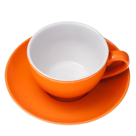 Empty orange cup and saucer isolated against white background.の写真素材