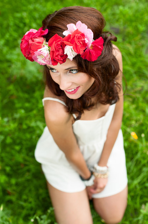 Gorgeous young woman  in  white dress with a flower wreath on her head.の写真素材