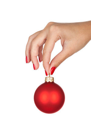 Woman holding christmas red ball, close-up of hand isolated on white.の写真素材