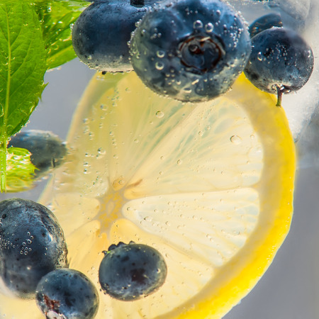 Summer lemonade with blueberries, lemon and mint. Shallow DOF.の写真素材