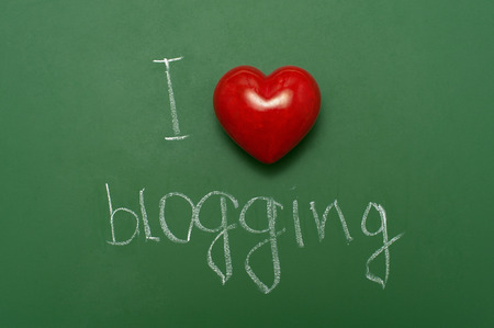 "I love blogging" handwritten on school green chalkboard.の写真素材