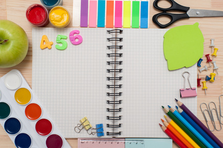 Photo of school gear over wood table background.の写真素材