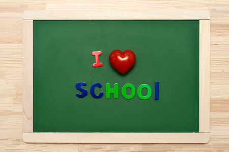 'I love school' phrase made with multicolored letters on green chalkboard.の写真素材