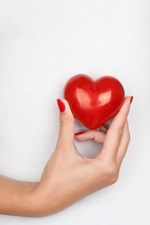 Giving love concept with hand holding a red heart.の写真素材