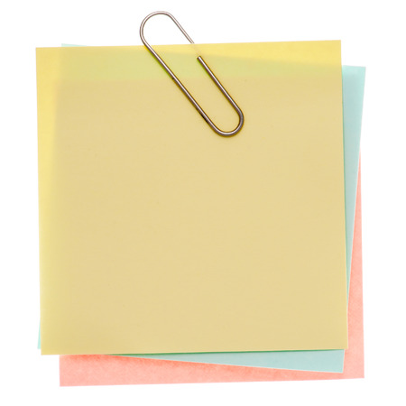 Stack of varicoloured memos with silver paper clip on a pure white background. Waiting for your message.の写真素材
