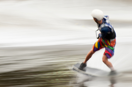KIEV, UKRAINE - SEPT 16: Wakeborder is participating in European Wakeboard Masters on September 16, 2008 in Kiev. Motion blurred panning shot.のeditorial素材