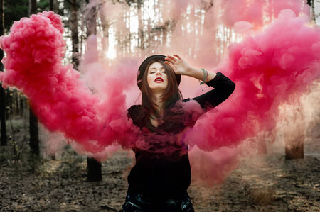 Beautiful fairy with pink smoke wings in the forest.の写真素材