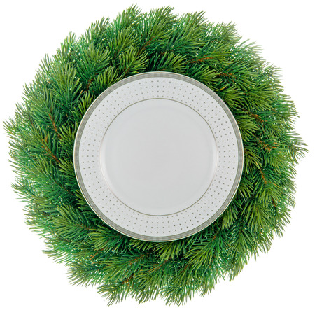 Plate in a christmas wreath isolated on white.の写真素材