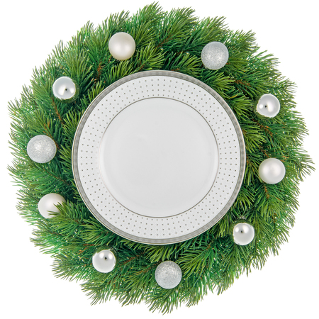 Plate in a decorated christmas wreath isolated on white.の写真素材