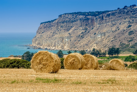 Straw bales on the field against Mediterranean sea and mountain  in Cyprus.の写真素材