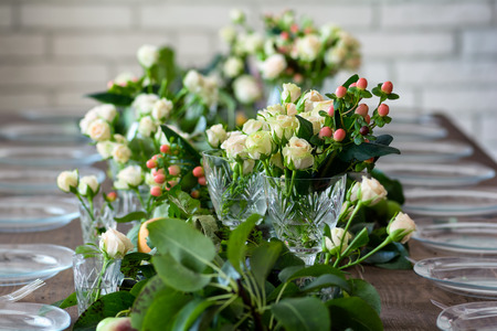 Table set for wedding or another catered event dinner, decorated with flowers.の写真素材