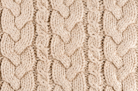 Knitted fabric texture close-up, beige color,  aran Sweater.の写真素材