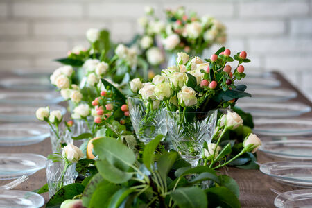 Table set for wedding or another catered event dinner, decorated with flowers.の写真素材