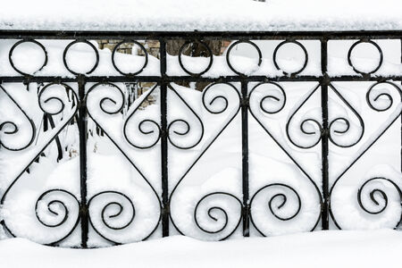 Metal decorative fence in the snowの写真素材