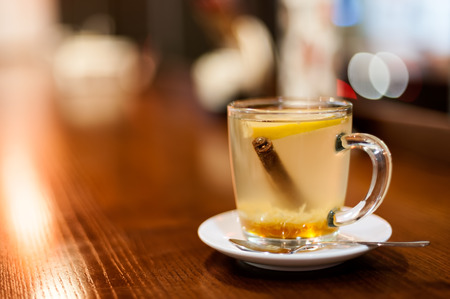 Herbal tea on wooden table in the cafe, blurred bokeh background,  soft focus.の写真素材