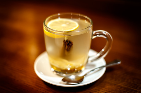 Herbal tea on wooden table in the cafe,  soft focus, vignetting.の写真素材