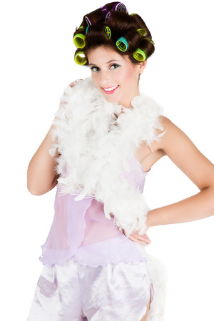 Sexy housewife in hair curlers isolated on white.の写真素材