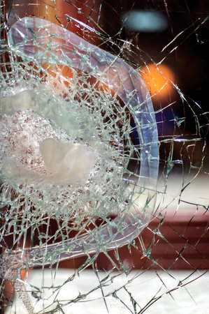 Broken glass in the street at night, close-up.