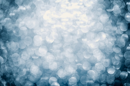 Blue background with shimmering glitter - Defocused lights.の写真素材