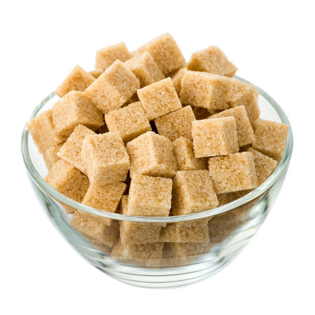 Brown sugar in a glass bowl isolated on a white background. Side view.の写真素材