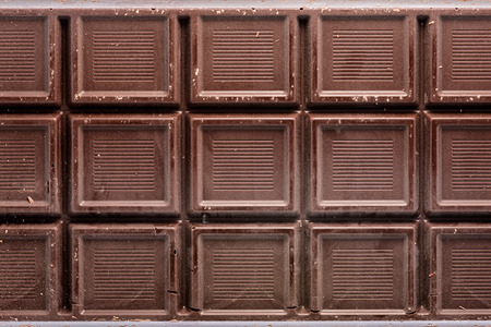 Close-up of rough dark chocolate bar as background.の写真素材