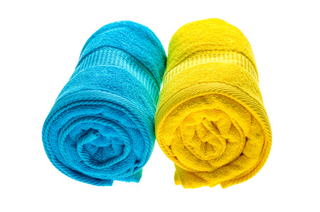 Blue and yellow towels isolated on white background.の写真素材