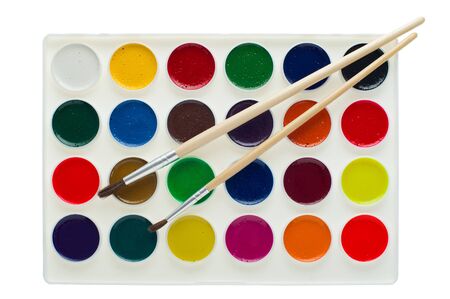 Set of watercolor paints with brushes in palette isolated on white.の写真素材